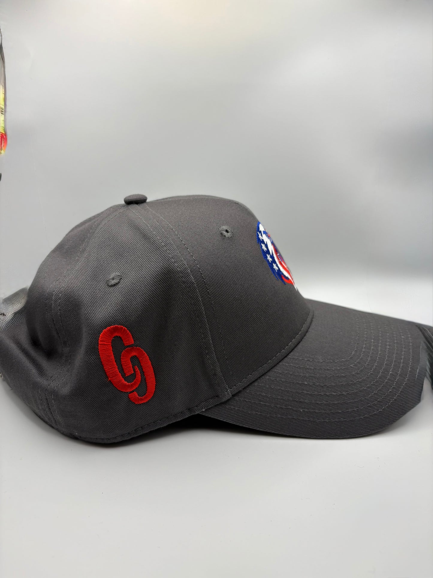 Grey Cap full material cap featuring embroidered red CG logo on side view 